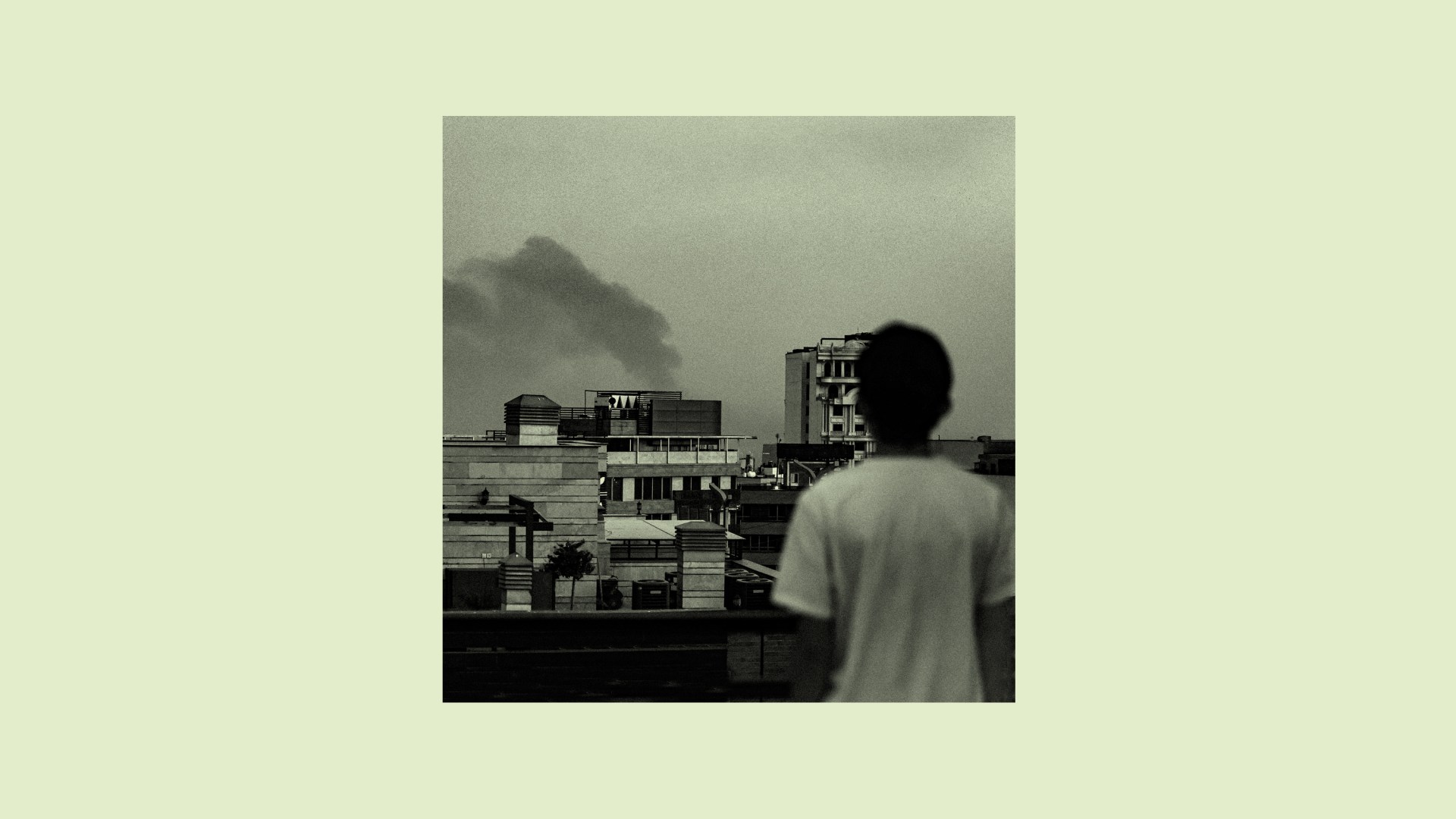 A boy watching an explosion from an Israeli airstrike in Iran.